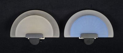 two white and blue wall hooks on a black background