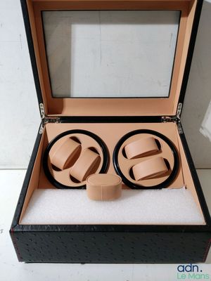 an open box with two watches inside of it on a white surface