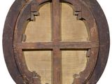 an image of a round wooden window on a white wall
