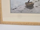 a picture of a dog pulling a boat on the beach