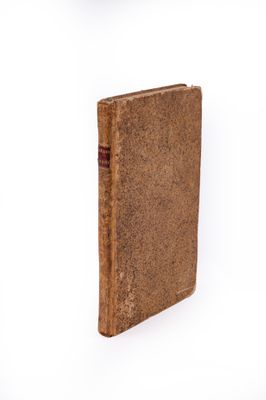 un vieux livre posé sur une surface blanche, sur fond blanc