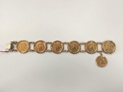 Bracelet en or jaune 18K(750/1000) serti en rang de 7 monnaies de 20 f - Photo 1