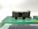 a small toy train on a green table next to a green box