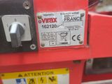 a close up of a red machine with a sign on it