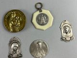 four silver and gold medals and a medal on a white surface