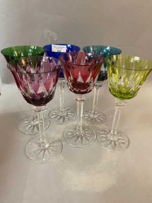 six wine glasses are lined up in a row on a table