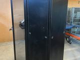 an image of a black metal cabinet in a warehouse