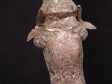 a close up of a statue of a person with a hat on