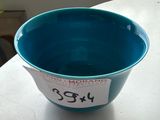 a blue bowl sitting on a table with a price tag on it
