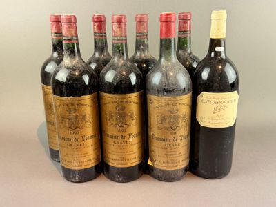 six bottles of wine are lined up in a row on a table