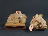 two figurines of a man and a woman laying on a bed