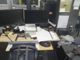 a desk with two monitors and a keyboard on it