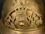 a gold helmet with a crown and laurels on it