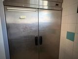 stainless steel double door freezer in a kitchen with tiled walls