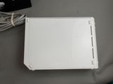 a white box with wires and a charger on a table