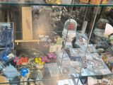a glass display case filled with jewelry and other items