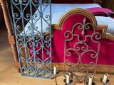 a bed with a red blanket and a red chair in front of it