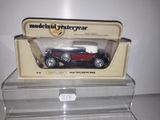 a model of a red car in a clear box