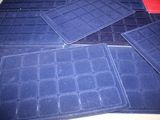 four blue mats on top of each other on a table
