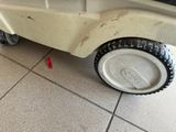 a toy car that is sitting on a tile floor