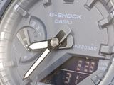 a close up of a watch on a white surface