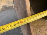 a measuring tape that is on the side of a pipe