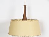 a close up of a lamp hanging from a ceiling on a white wall