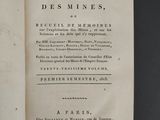 an old book with writing on it sitting on a table