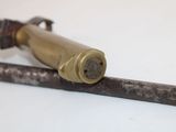 a close up of a metal object on a white surface