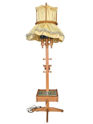 a lamp that is on a stand with a lamp shade on it