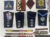 some of the badges are laid out on a white surface