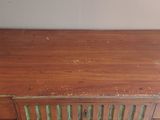 a wooden desk with a drawer on top of it