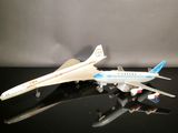 two model airplanes sitting on a black surface