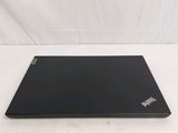 a black laptop sitting on a white surface with a white background
