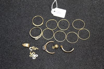 a lot of rings and earrings on a black surface