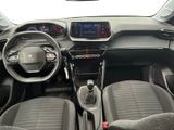 the interior of a small car with a steering wheel and dashboard controls