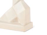 a white sculpture of a cat sitting on a table