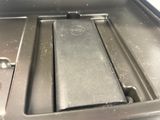 a close up of a metal tray with a cell phone in it
