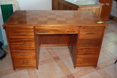 a wooden desk with a checkered top in a room