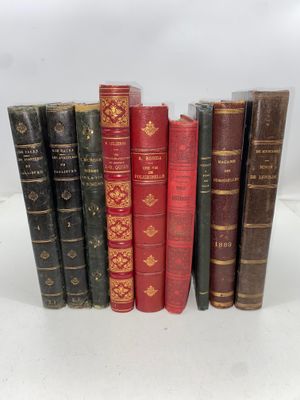 several old books are lined up in a row on a table