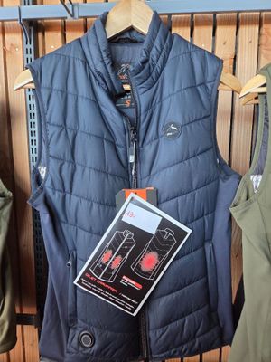 a blue vest on a hanger next to a pair of green pants