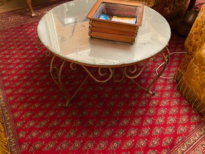 a glass table with books on it in a living room