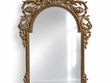 a large ornate gold mirror with a decorative frame