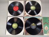 three black vinyl records sitting on top of each other on a table