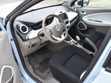 the interior of a small car with a steering wheel and a dash board