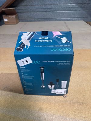 the box is open to show the contents of a coffee maker