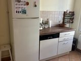 a small kitchen with a refrigerator and a dishwasher