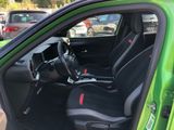 a green car with black seats and a black steering wheel