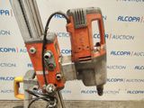 an image of a drill on a stand in front of a wall
