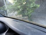 a car dashboard with a view of a tree through the windshield